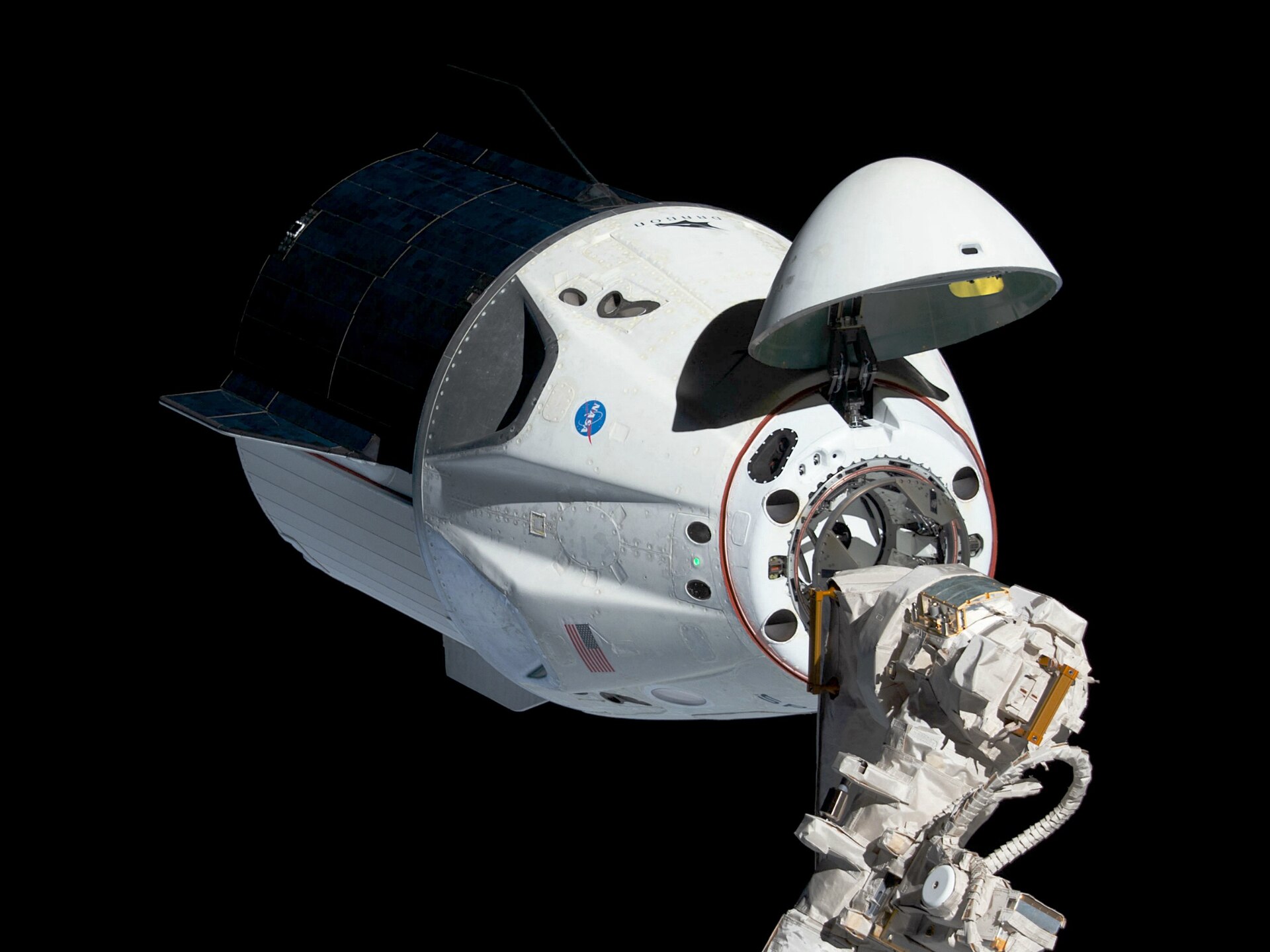 Uncrewed Crew Dragon approaching the ISS with nose cone open on Demo-1