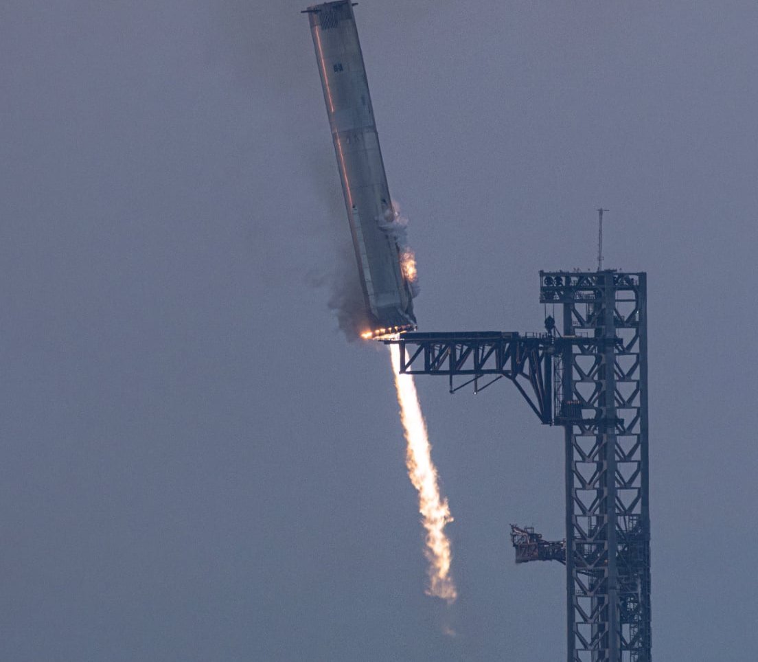 Super Heavy booster caught by the Mechazilla chopstick arms on Starship Flight 5