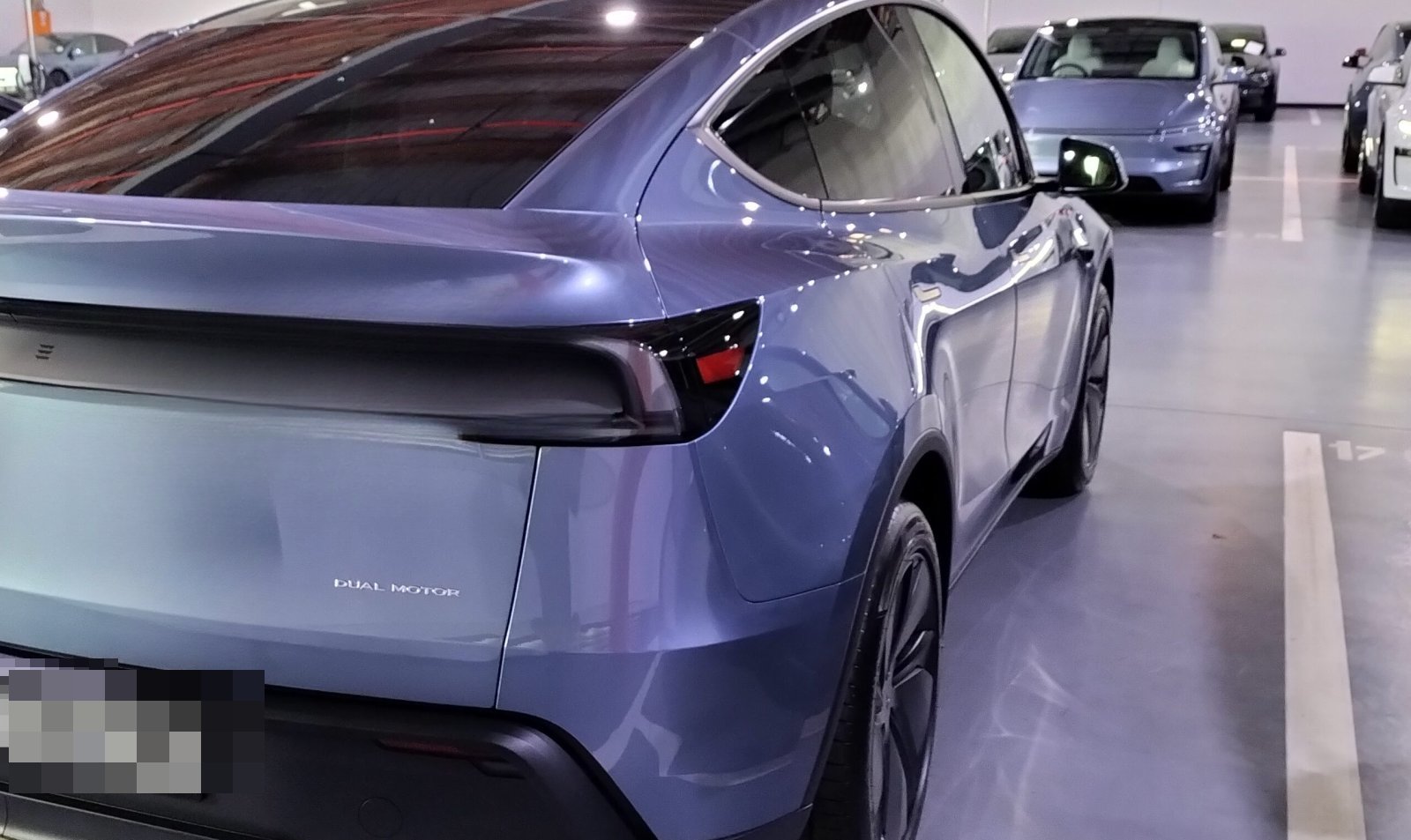 Rear three-quarter view of glacier blue Model Y Juniper at Tesla Sydney delivery