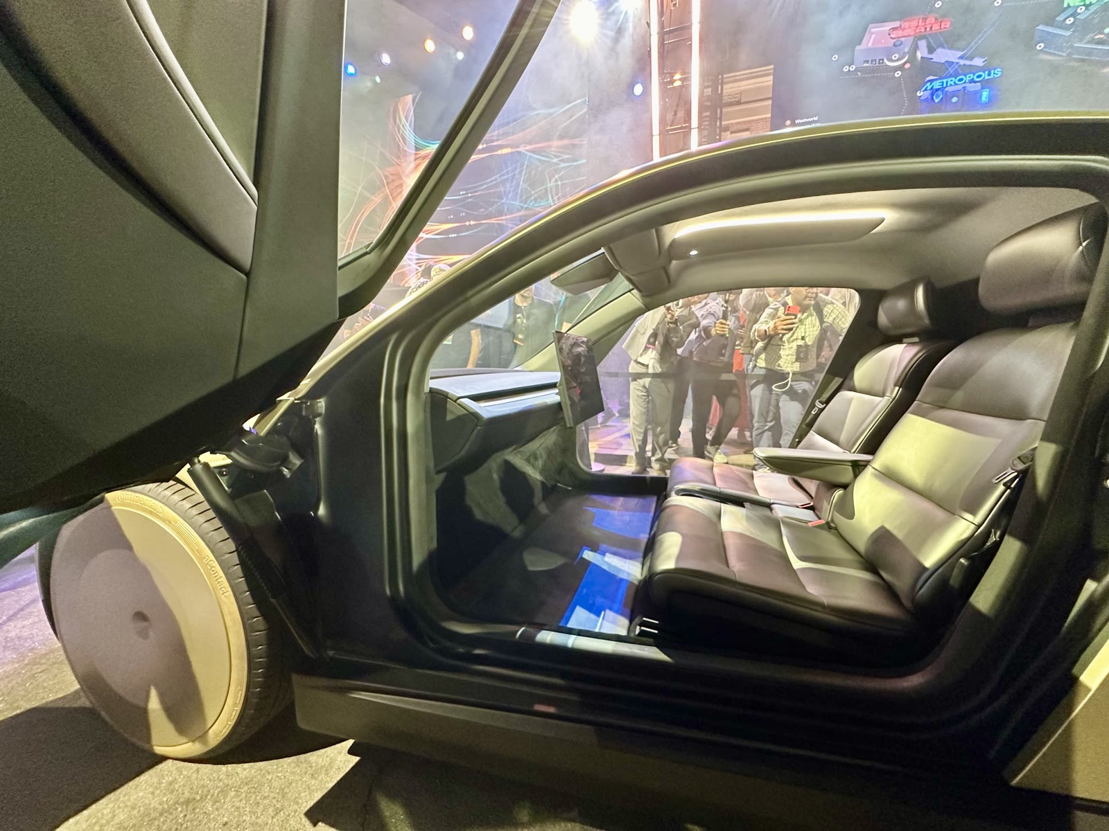 Interior of Tesla Cybercab with two seats and large central screen, no steering wheel